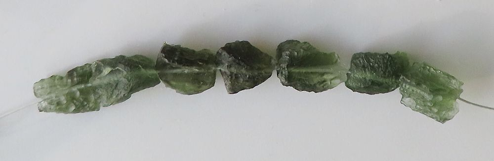 String of drilled Moldavites