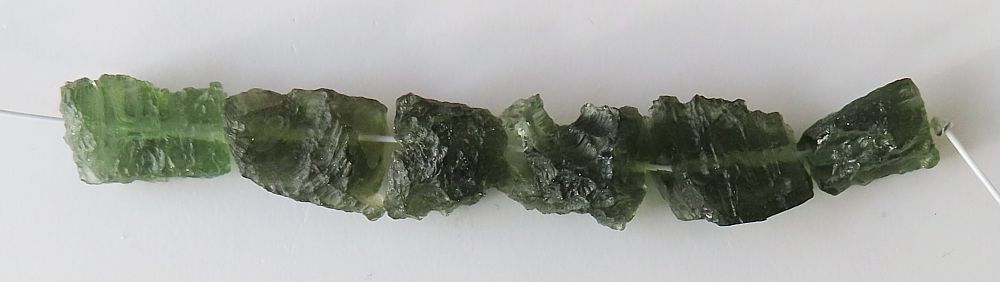String of drilled Moldavites