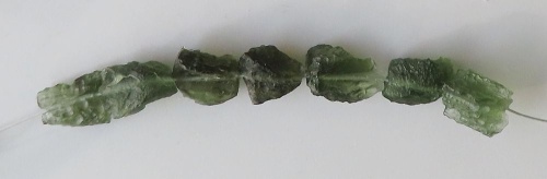 String of drilled Moldavites