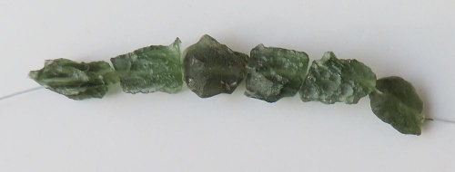 String of drilled Moldavites