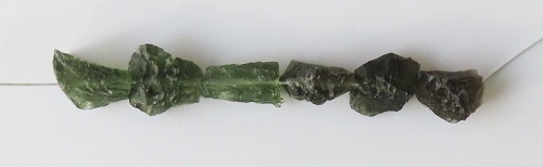 String of drilled Moldavites