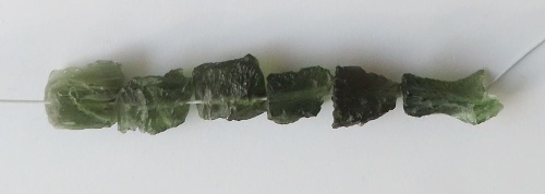 String of drilled Moldavites